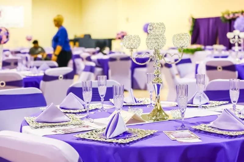Purple table setting with crystal candelabra, lavender napkins and champagne flutes